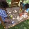 KidKraft Ainsley Wooden Outdoor Swing Set with Slide, Chalk Wall, Canopy and Rock Wall